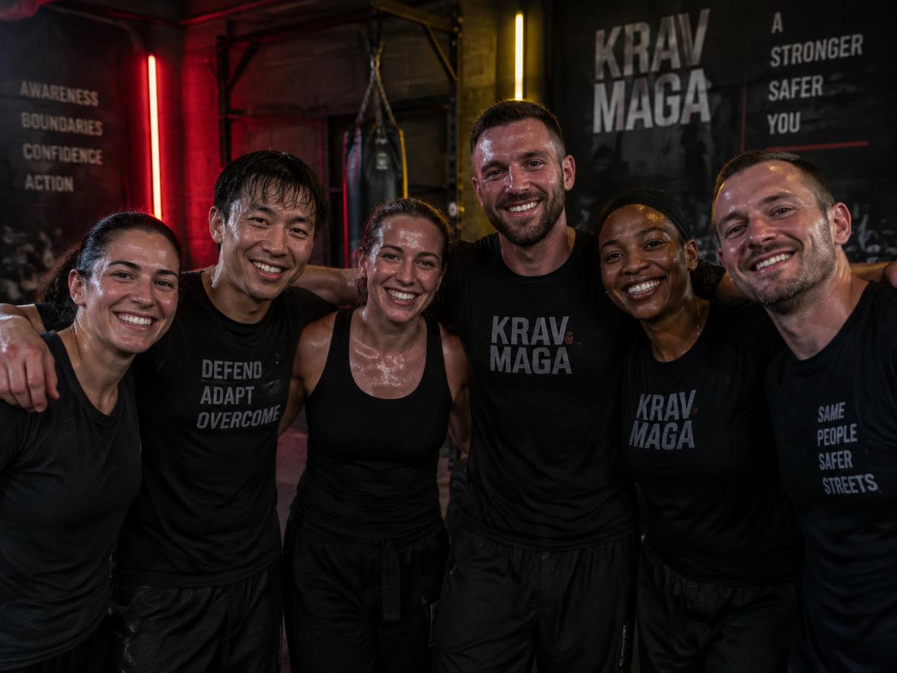 A group finishing a high-energy Krav Maga class